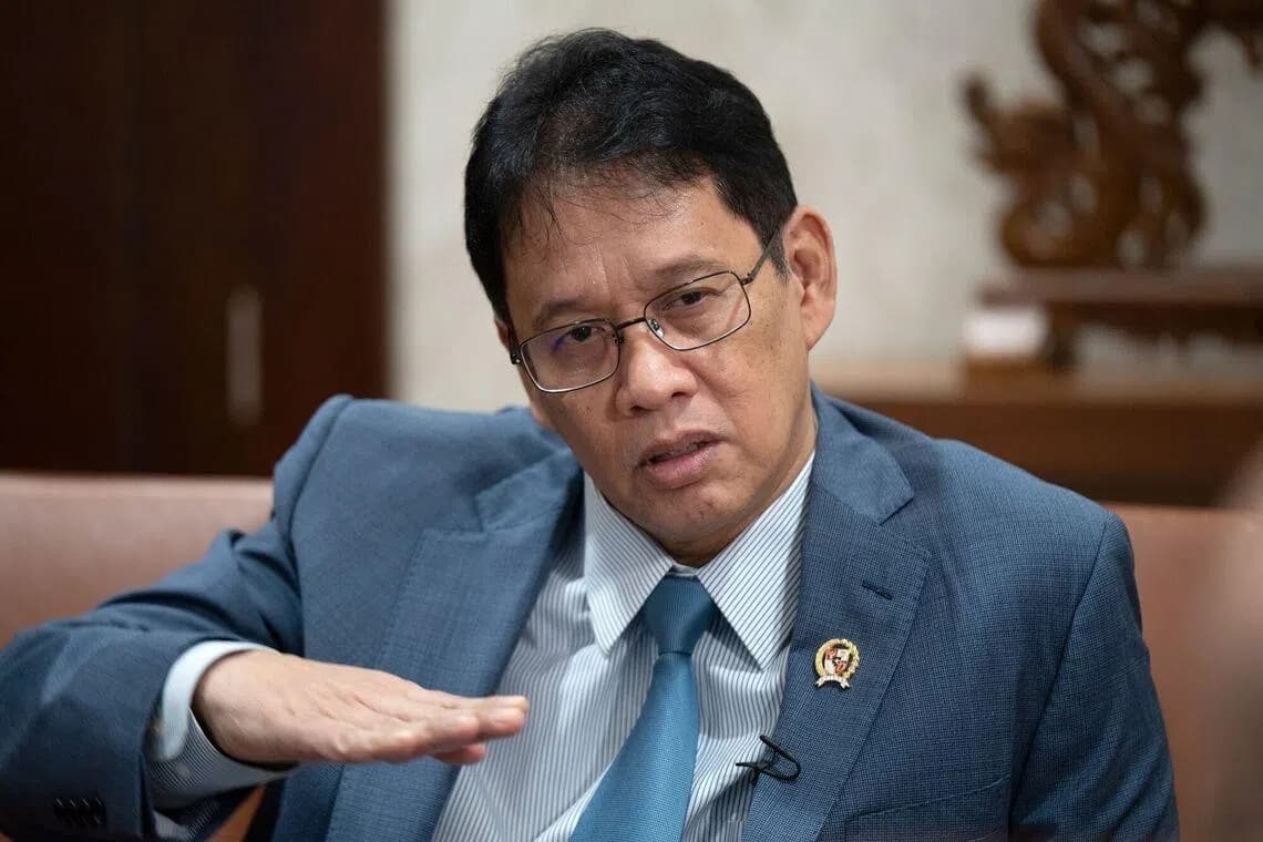 A senior Indonesian government official gestures while speaking during an interview in Jakarta