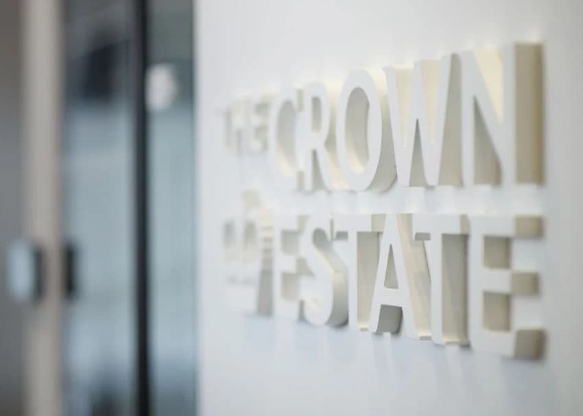 A close up of The Crown Estate signage on an office wall