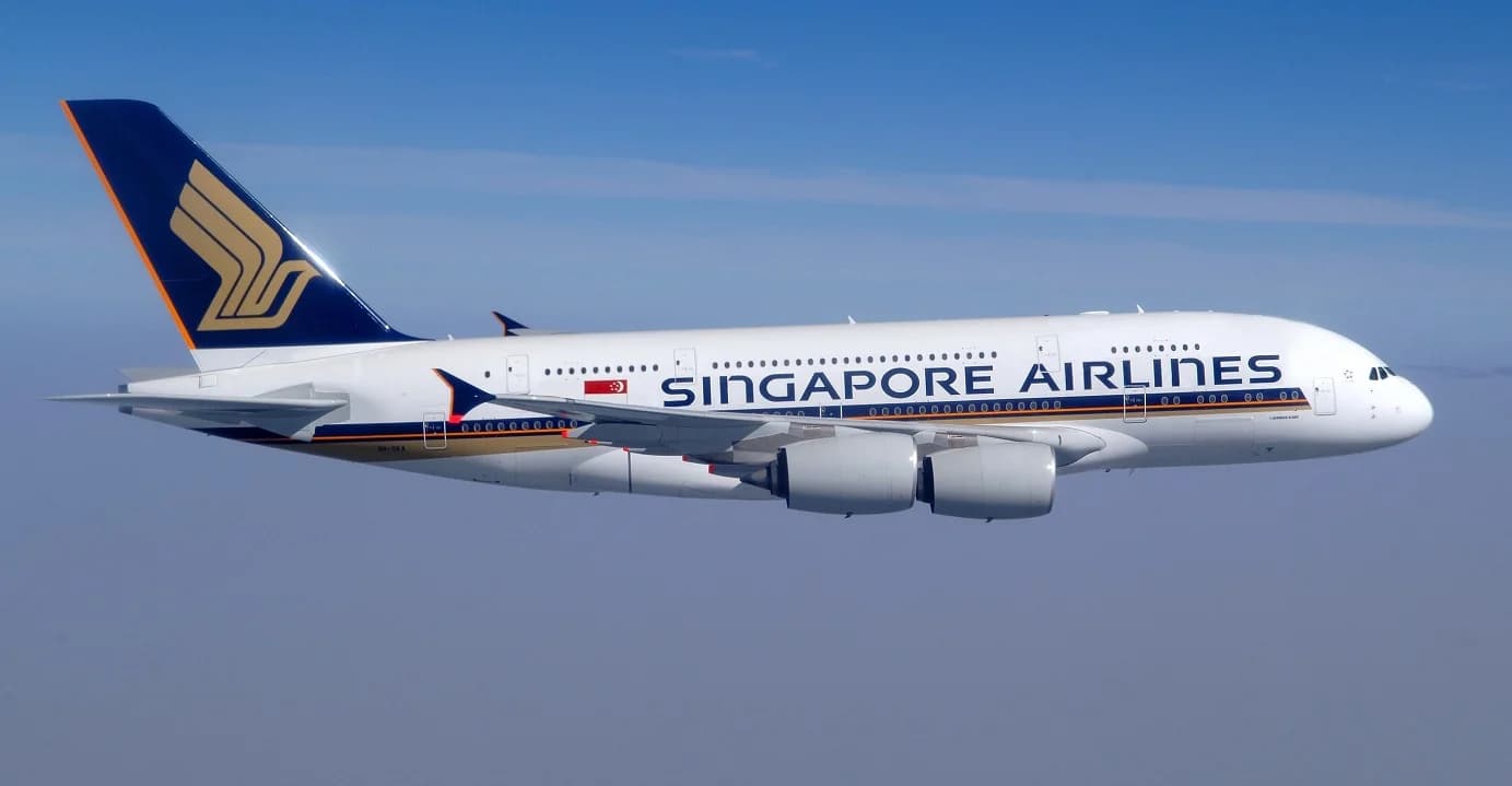 A Singapore Airlines Airbus A380 in flight against a clear blue sky