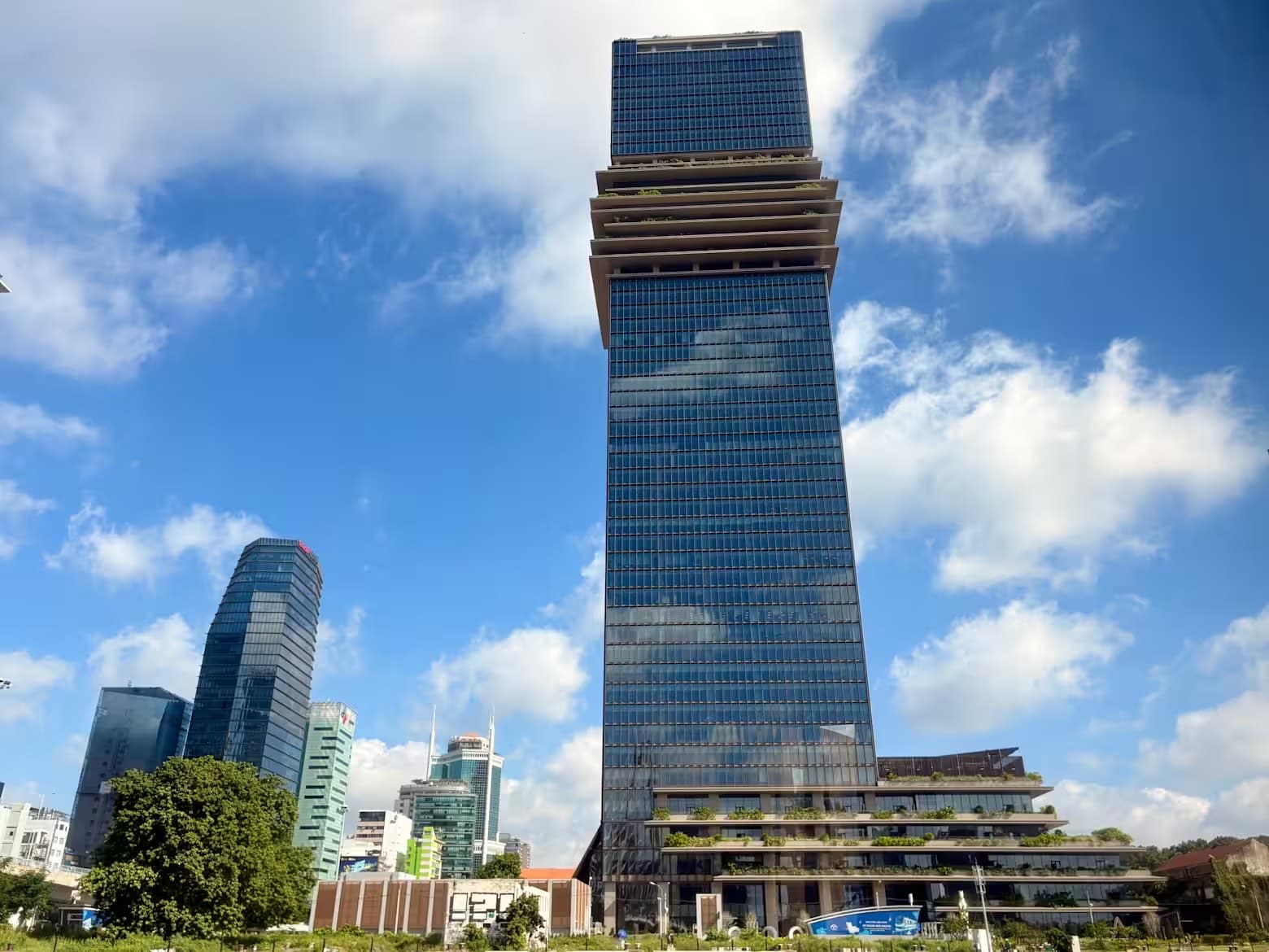 The Saigon Marina financial tower rising over the Ho Chi Minh City skyline against a blue sky
