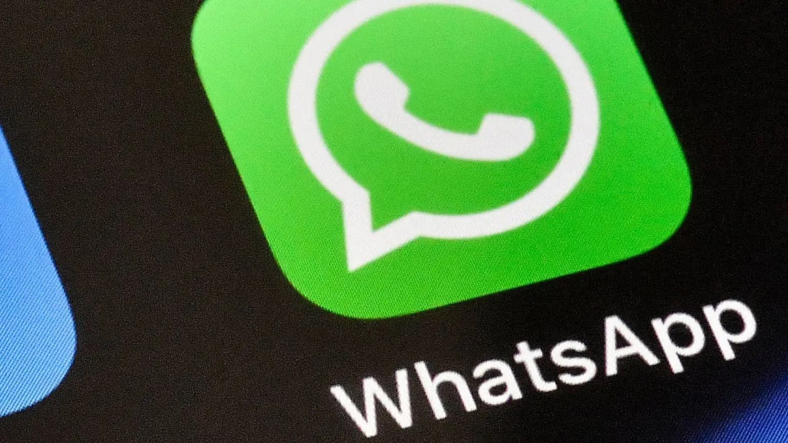 The WhatsApp app icon shown in close up on a phone screen