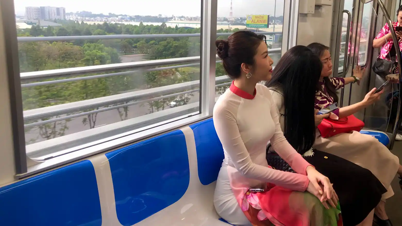 Passengers seated inside a Ho Chi Minh City metro train car