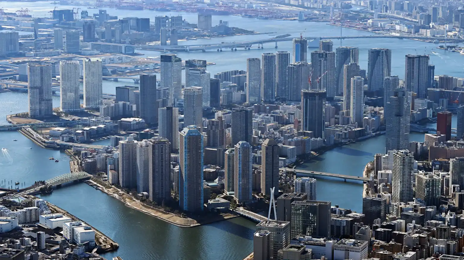 An aerial view of high-rise condominium towers along a river in central Tokyo